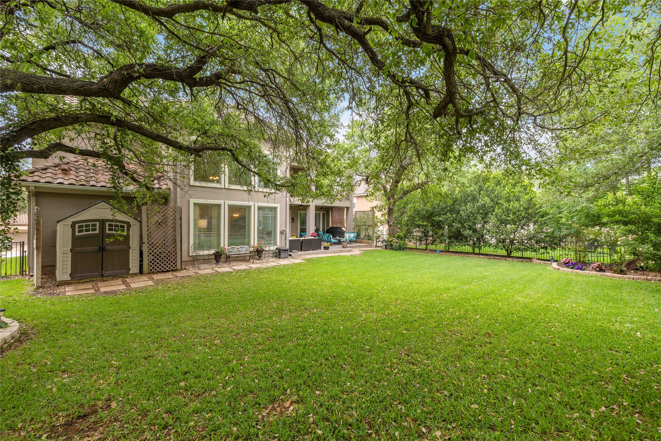 15200 Spillman Ranch Loop Austin, TX 78738 - Photo 38 of 40 The property features a spacious lawn with mature trees providing ample shade