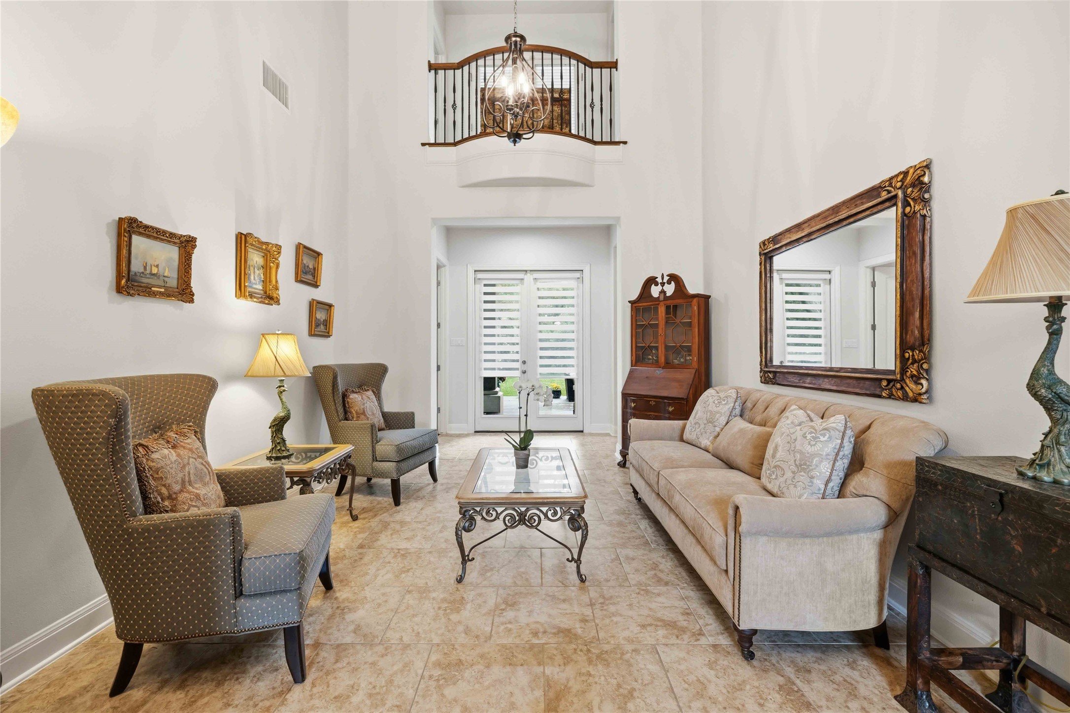 15200 Spillman Ranch Loop Austin, TX 78738 - Photo 4 of 40 This spacious living area features high ceilings, tile flooring, and a decorative chandelier