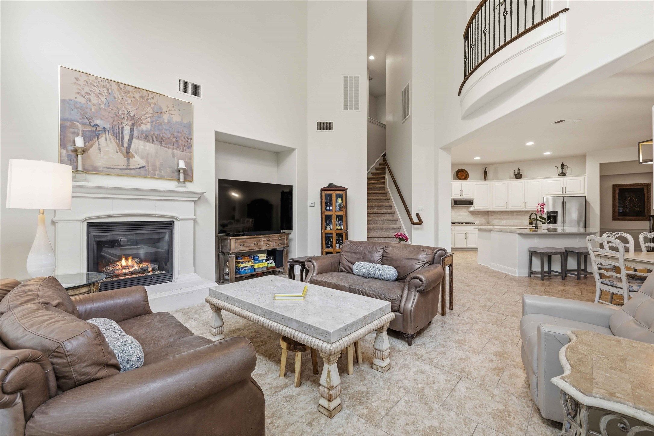 15200 Spillman Ranch Loop Austin, TX 78738 - Photo 8 of 40 Living area featuring a fireplace with a white mantel, high ceilings, and tiled flooring