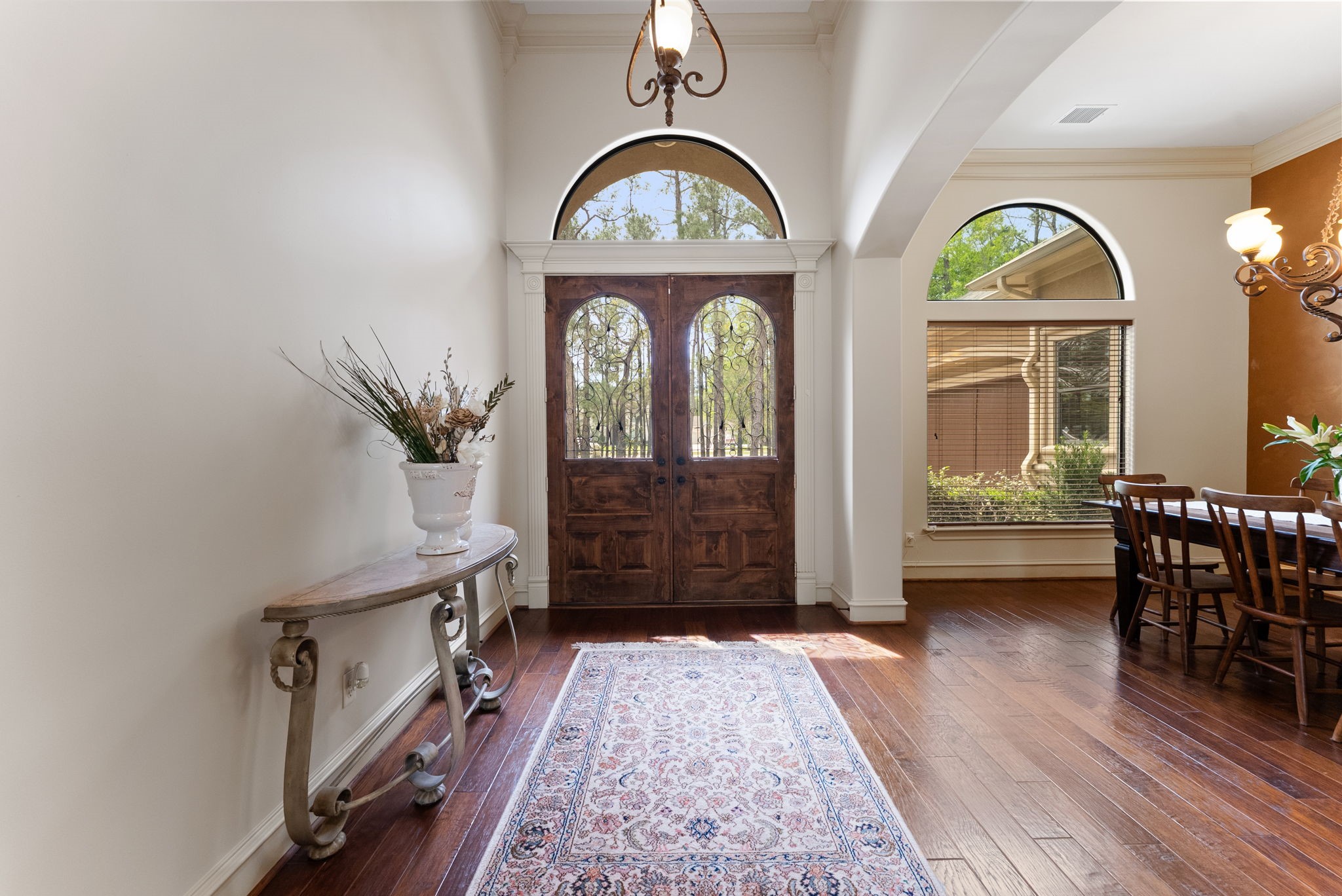 3907 Rayford Road Spring, TX 77386 - Photo 9 of 38 The double front doors with wrought iron accents, framed by an arched transom window and detailed trim work, set the tone for the craftsmanship found throughout the home.
