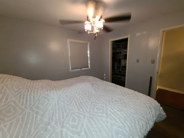 a bedroom with a bed and a chandelier