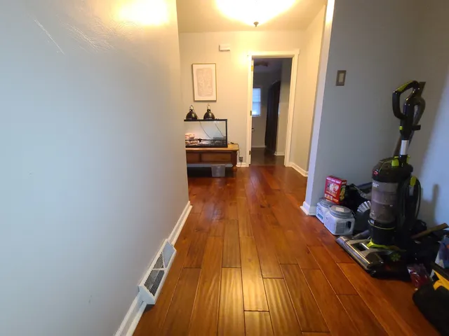 a view of a room with wooden floor