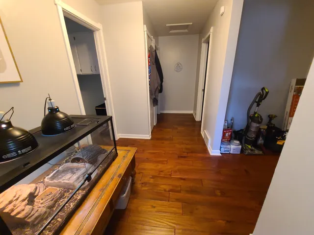 a room with wooden floor and furniture