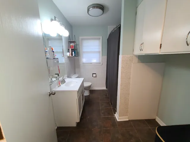 a utility room with cabinets washer and dryer