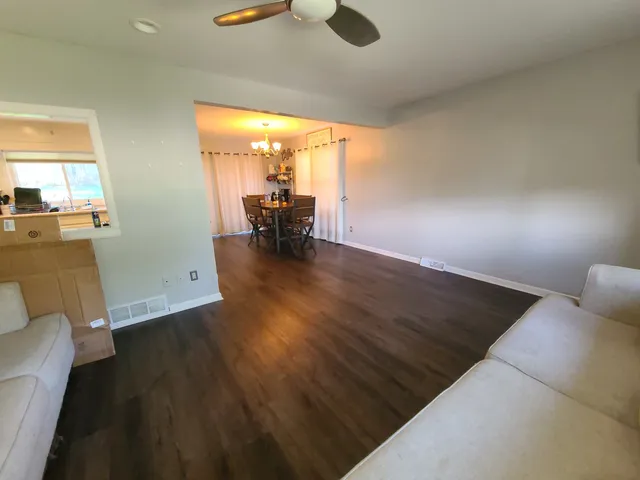 a view of a dining room with furniture and wooden floor