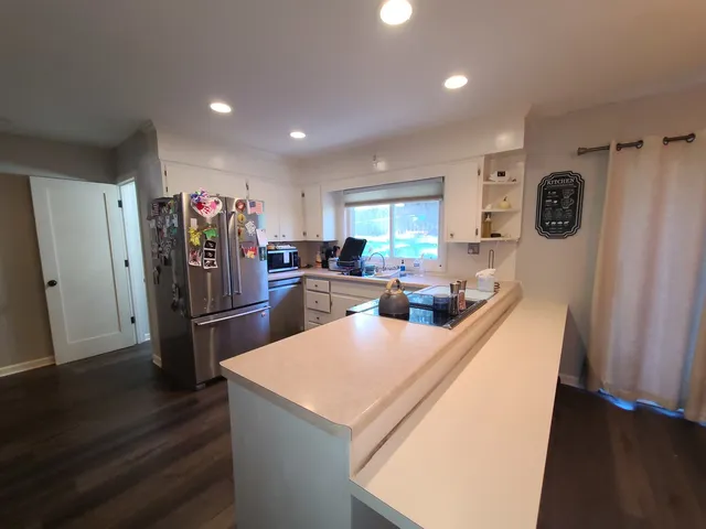 a room with pool table and windows