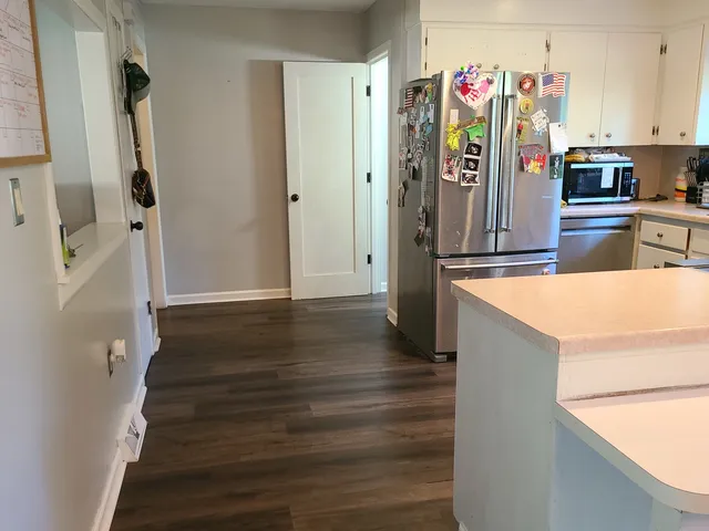 a kitchen with a sink appliances and cabinets