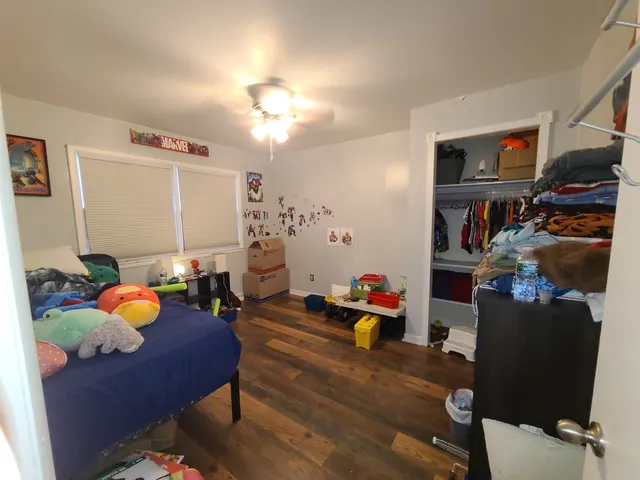 a bedroom with furniture and a flat screen tv
