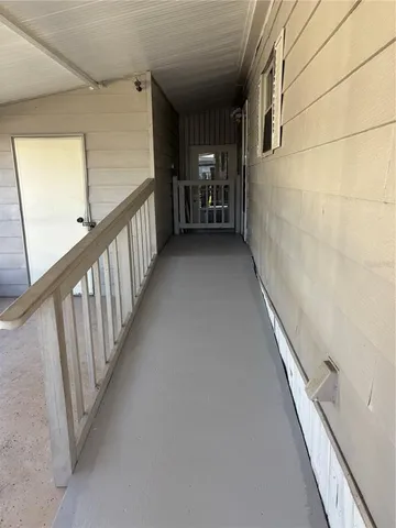 a view of a hallway with seating area