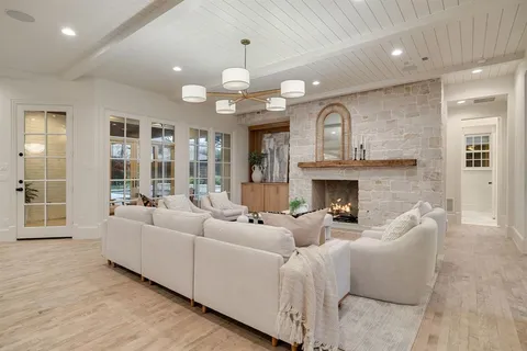 a living room with furniture wooden floor and a fireplace