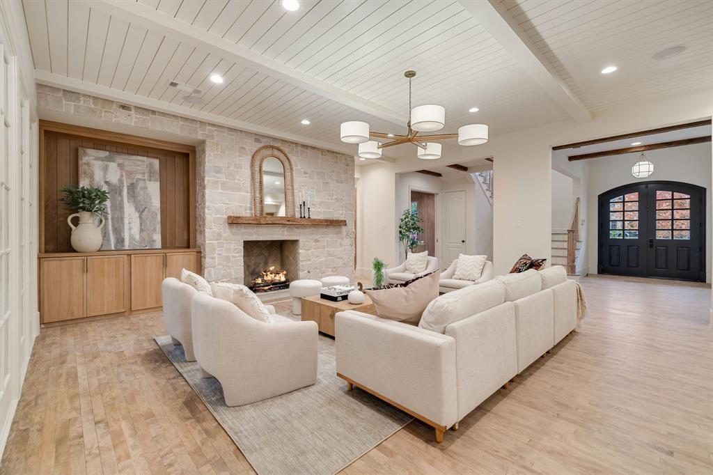 6411 Orchid Lane Dallas, TX 75230 - Photo 14 of 40 a living room with furniture a fireplace and a chandelier