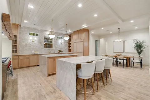 a large kitchen with a table and chairs