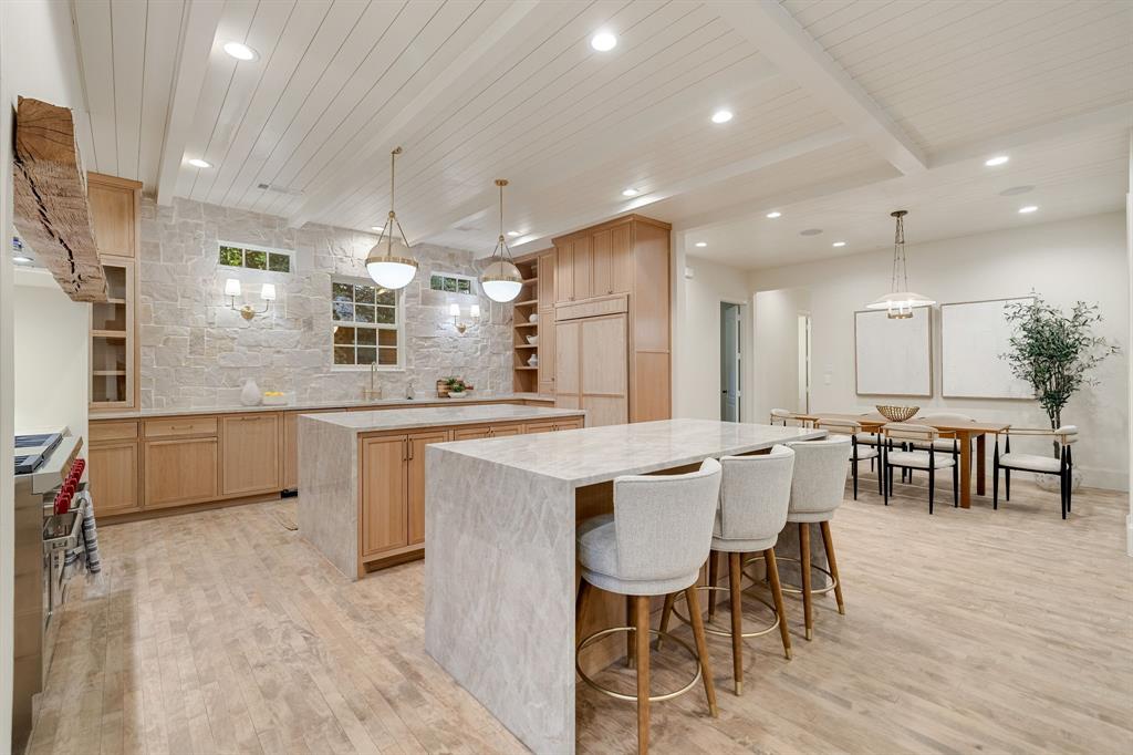 6411 Orchid Lane Dallas, TX 75230 - Photo 18 of 40 a large kitchen with a table and chairs