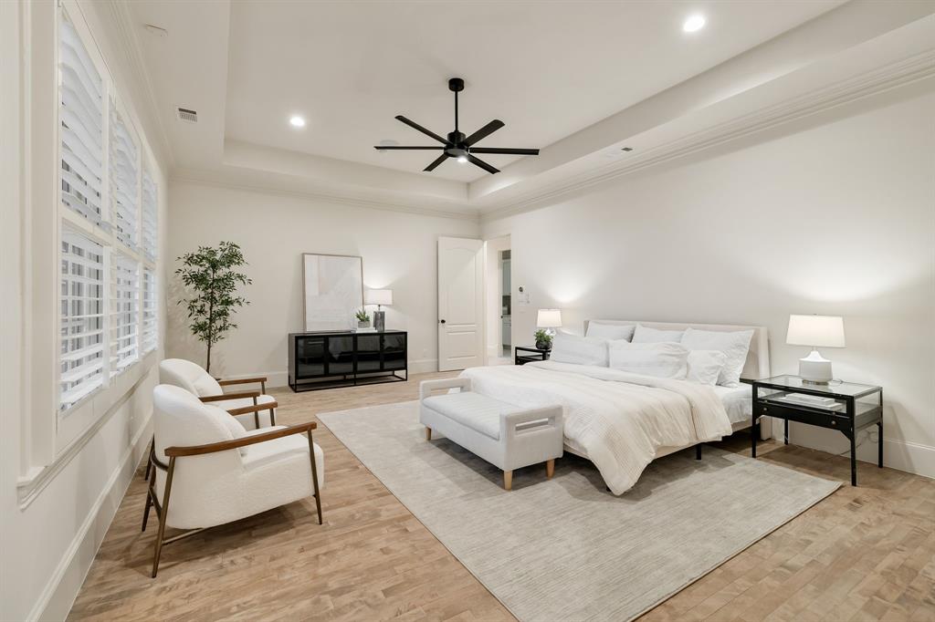6411 Orchid Lane Dallas, TX 75230 - Photo 23 of 40 a spacious bedroom with a bed couch and a ceiling fan