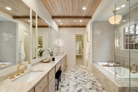 a spacious bathroom with a bathtub sink and mirror