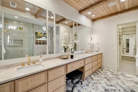 a bathroom with a sink double vanity and a mirror