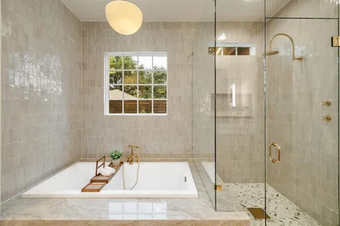 a bathroom with a tub and shower