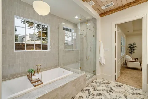a bathroom with a tub sink and a mirror