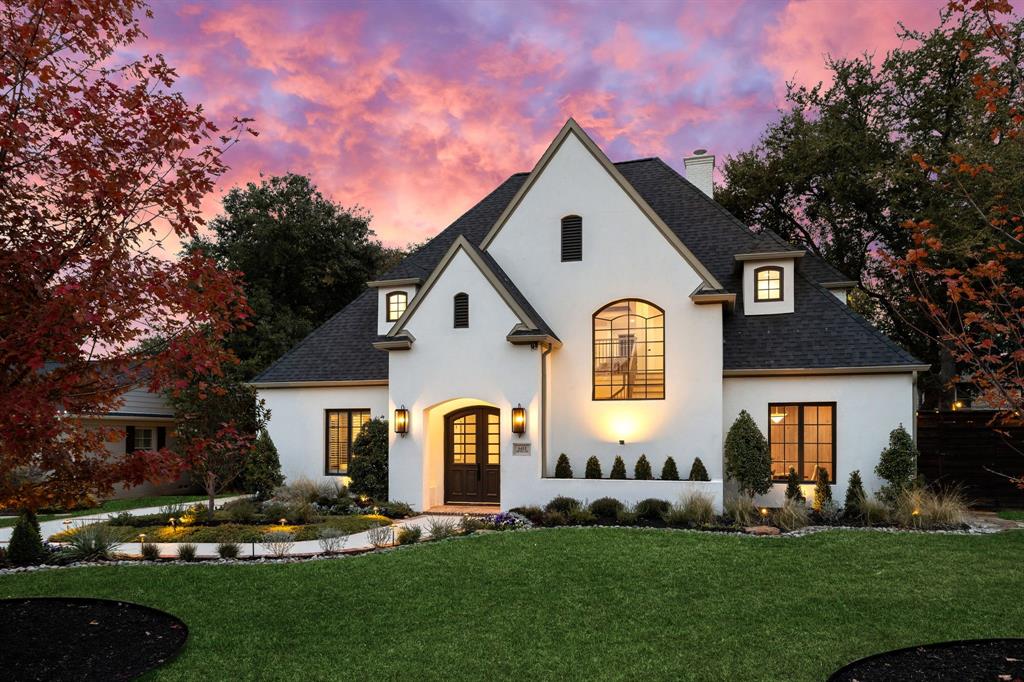 6411 Orchid Lane Dallas, TX 75230 - Photo 3 of 40 a front view of a house with a garden and plants