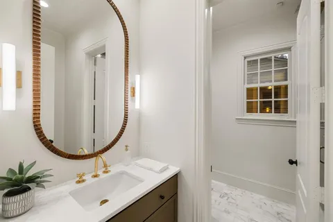 a bathroom with a sink a mirror and a shower