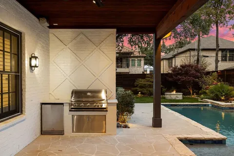 a kitchen view with a fireplace and a flat screen tv