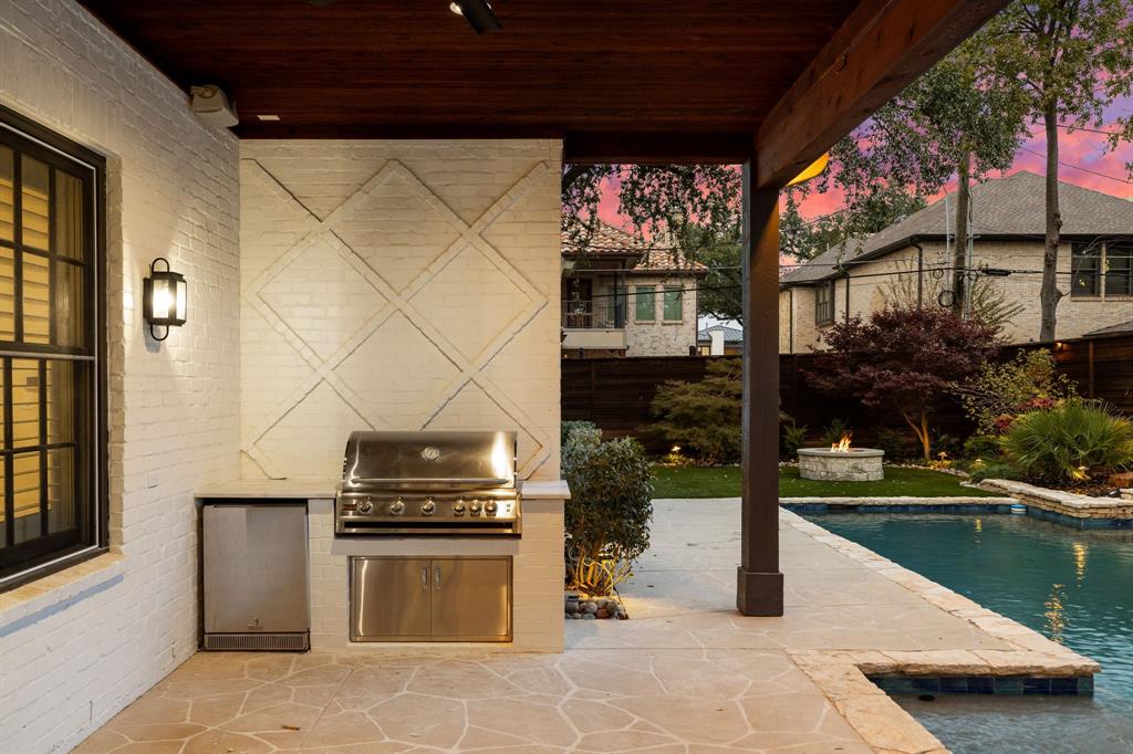 6411 Orchid Lane Dallas, TX 75230 - Photo 38 of 40 a kitchen view with a fireplace and a flat screen tv