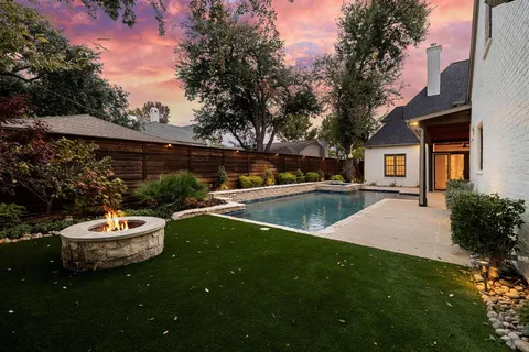 a view of a house with a yard and sitting area