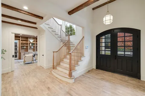 a view of entryway with stairs and wooden floor