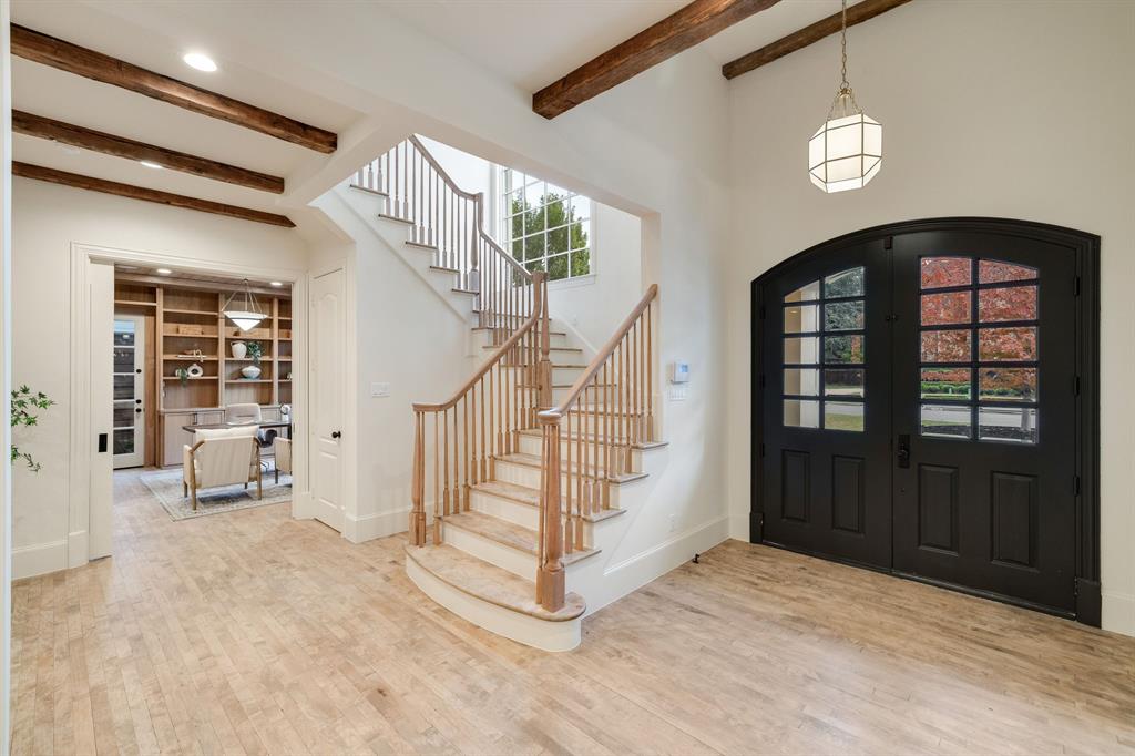 6411 Orchid Lane Dallas, TX 75230 - Photo 4 of 40 a view of entryway with stairs and wooden floor