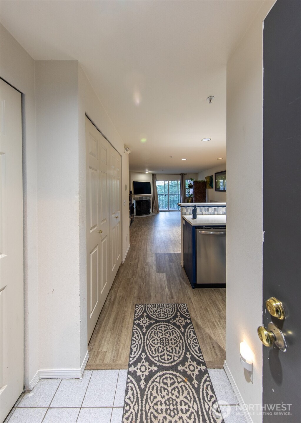15917 Waynita Way Northeast, Unit E206 Bothell, WA 98011 - Photo 5 of 27 a kitchen with stainless steel appliances granite countertop a sink stove and cabinets
