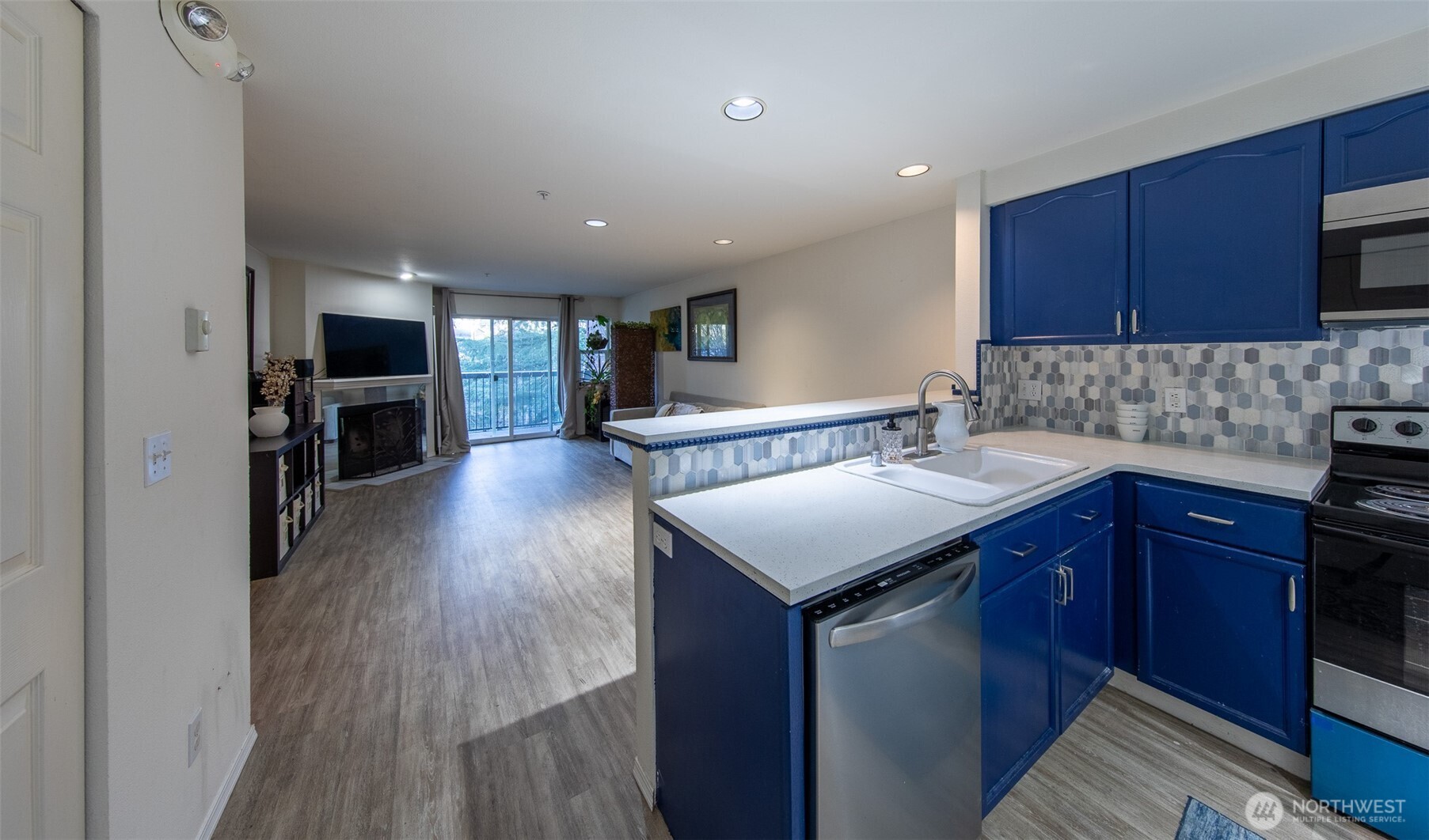 15917 Waynita Way Northeast, Unit E206 Bothell, WA 98011 - Photo 6 of 27 a kitchen with a sink cabinets and wooden floor
