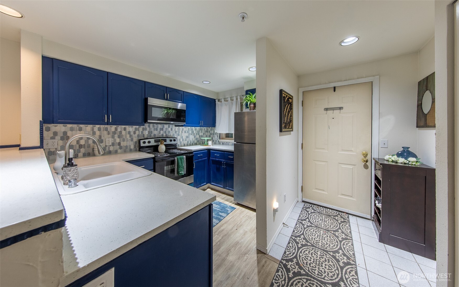 15917 Waynita Way Northeast, Unit E206 Bothell, WA 98011 - Photo 8 of 27 a kitchen with a refrigerator and a stove top oven