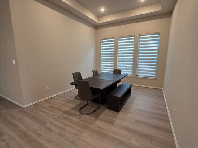 a dining room with a wooden table and chairs