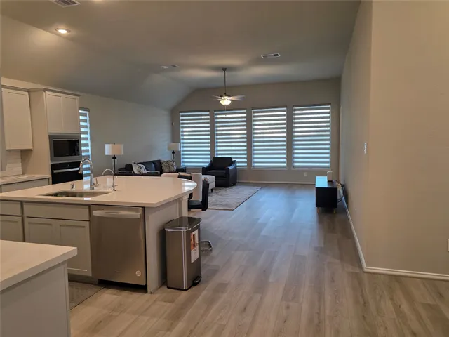 a room with a wooden floor and a window