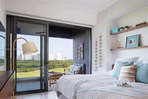 a bedroom with a bed and a large window with view of bedroom