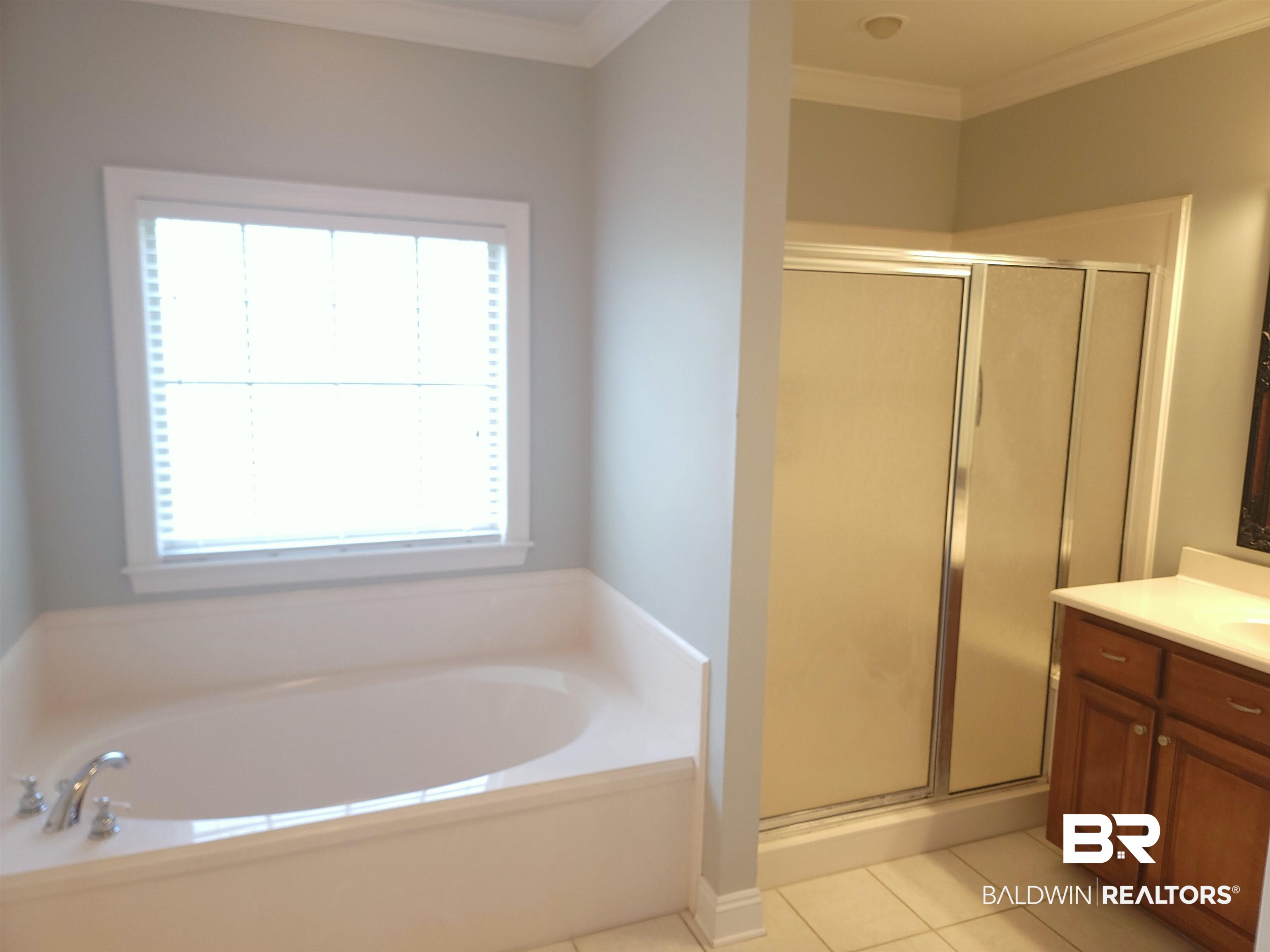 306 South Tee Drive Fairhope, AL 36532 - Photo 17 of 37 Bathroom featuring tile patterned flooring, vanity, separate shower and tub, and crown molding