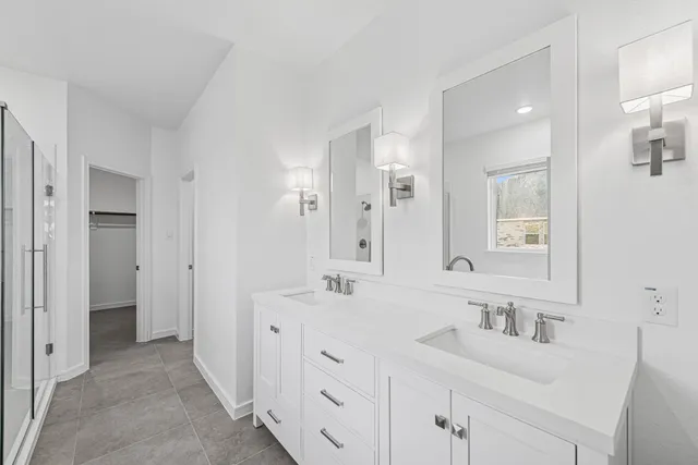 a bathroom with a double vanity sink mirror and