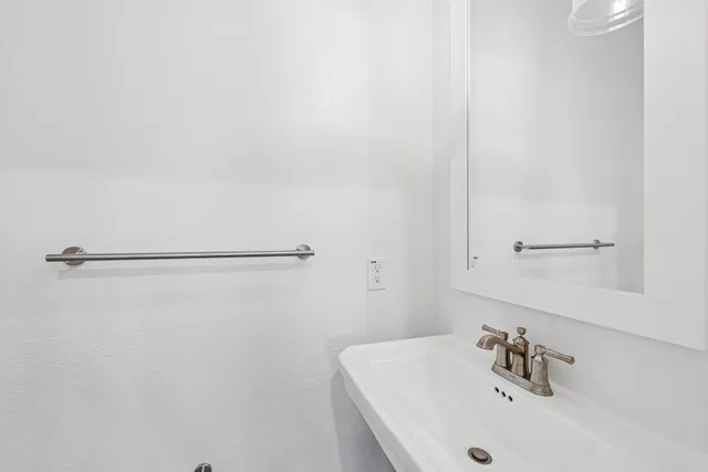 a bathroom with a sink and a white vanity