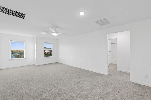 an empty room with windows and closet