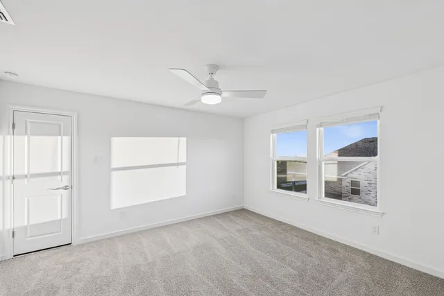 an empty room with windows and closet