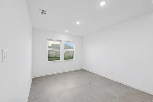 an empty room with a ceiling fan and a fan