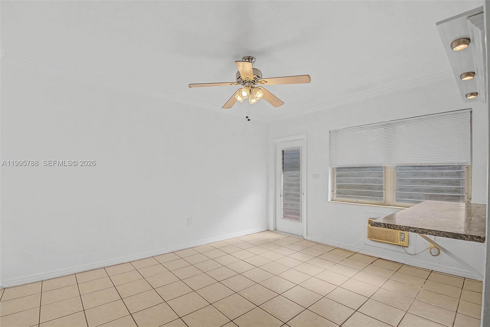 60 Northwest 79th Street, Unit 23 Miami, FL 33150 - Photo 5 of 23 a view of a room with rack and window