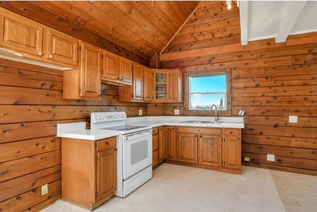 a kitchen with granite countertop a sink stainless steel appliances and cabinets