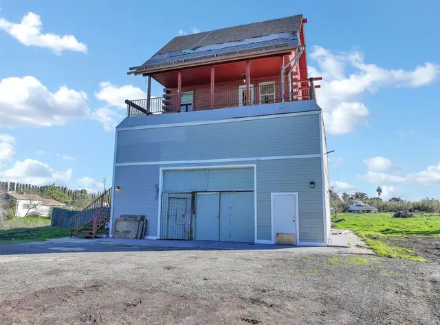 an aerial view of a house with backyard