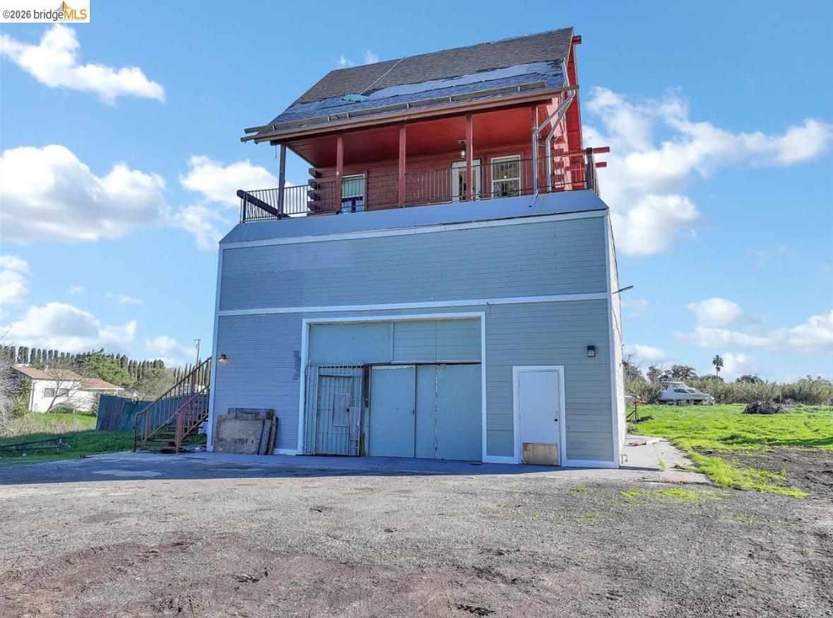 5980 Piper Road Bethel Island, CA 94511 - Photo 23 of 24 Rear view of house featuring a balcony and stairway