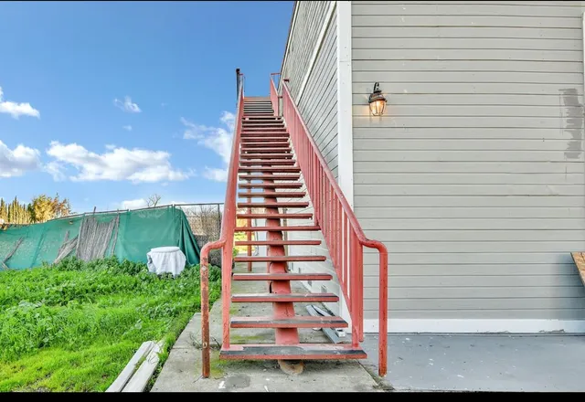a view of a backyard with sitting area
