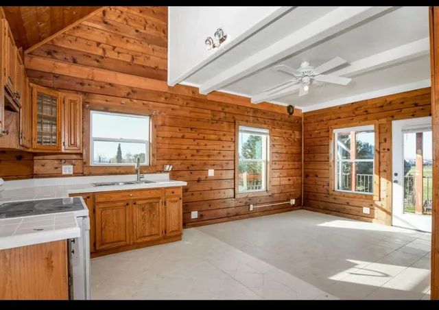 a view of a kitchen with stainless steel appliances granite countertop a stove a sink and a granite counter tops
