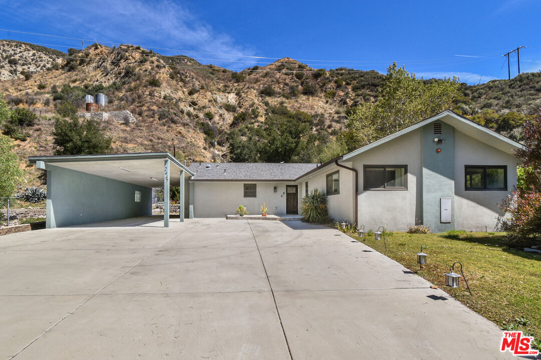 2447 Stonyvale Road Tujunga, CA 91042 - Photo 3 of 33 a front view of a house with a yard and garage