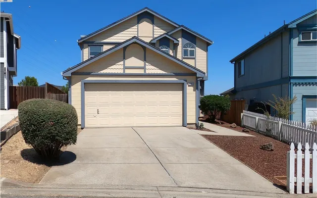 a front view of a house with garage