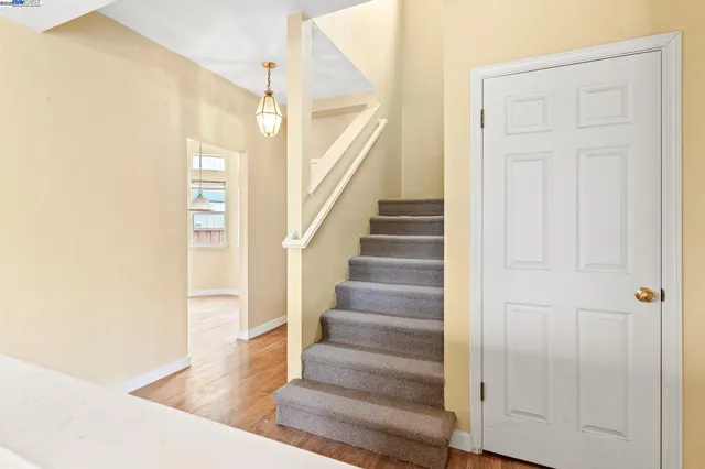 a view of entryway and hall with wooden floor